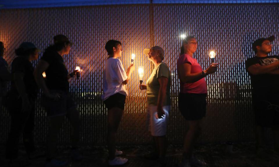 Activists hold a candlelight vigil at the perimeter fence securing a US Border Patrol station in Clint, Texas.