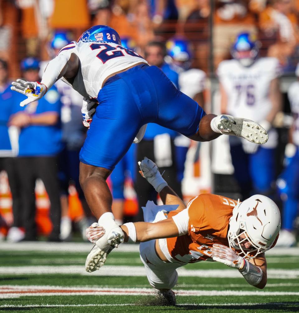 Texas defensive back Michael Taaffe (16) tackles Kansas running back Daniel Hishaw Jr. (20) in the fourth quarter of the Longhorns' game against the Kansas Jayhawks this year on Sept. 30 at Darrell K Royal-Texas Memorial Stadium in Austin. Texas won the game 40-14.