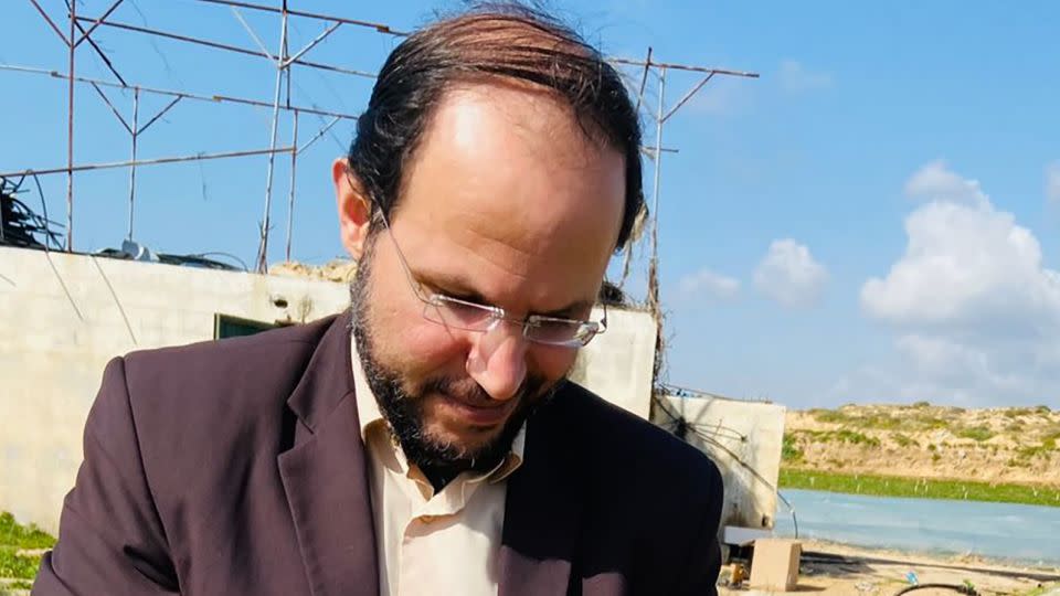 Refaat Alareer, a prominent Palestinian professor, poet and writer, was killed in an airstrike in northern Gaza, on December 7. His friend and colleague, Mosab Abu Toha, took this photo of Alareer picking strawberries in Gaza, on March 27, 2022. - Courtesy Mosab Abu Toha