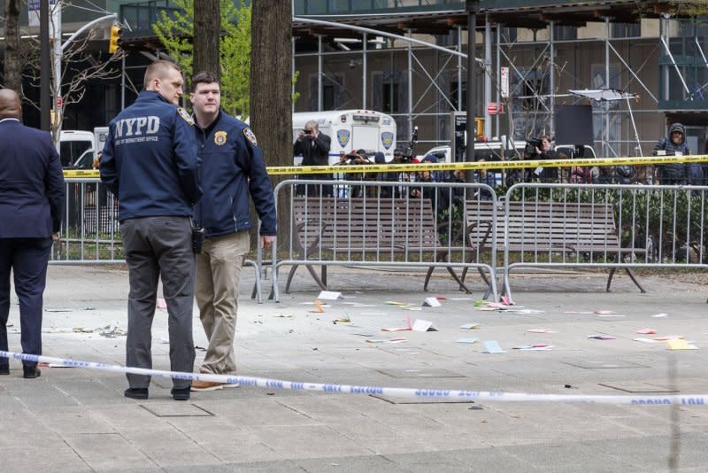 Emergency personnel on Friday assess the scene where a man set himself on fire at Collect Pond Park, outside Manhattan Criminal Court, where former president Donald Trump was attending jury selection for his criminal trial on Friday. Photo by Sarah Yenesel/EPA-EFE