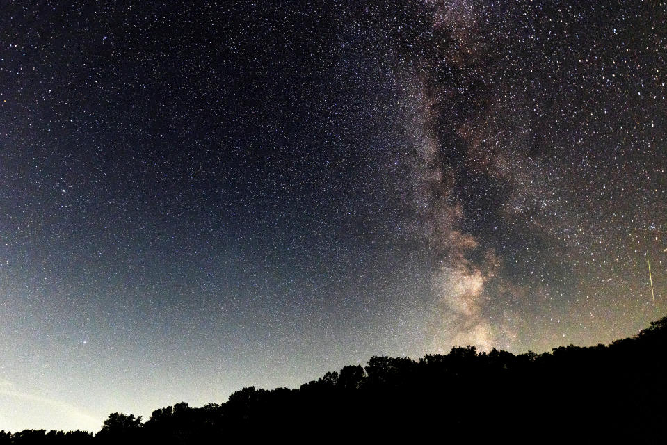 Starry night sky with several white streaks.