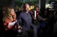 Greek Finance Minister Yanis Varoufakis surrounded by the media as he leaves Finance Ministry building in Athens, Greece, July 1, 2015. REUTERS/Marko Djurica