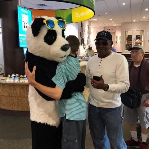 Pantwon gives a big bear hug to a zoo visitor in Washington, D.C.