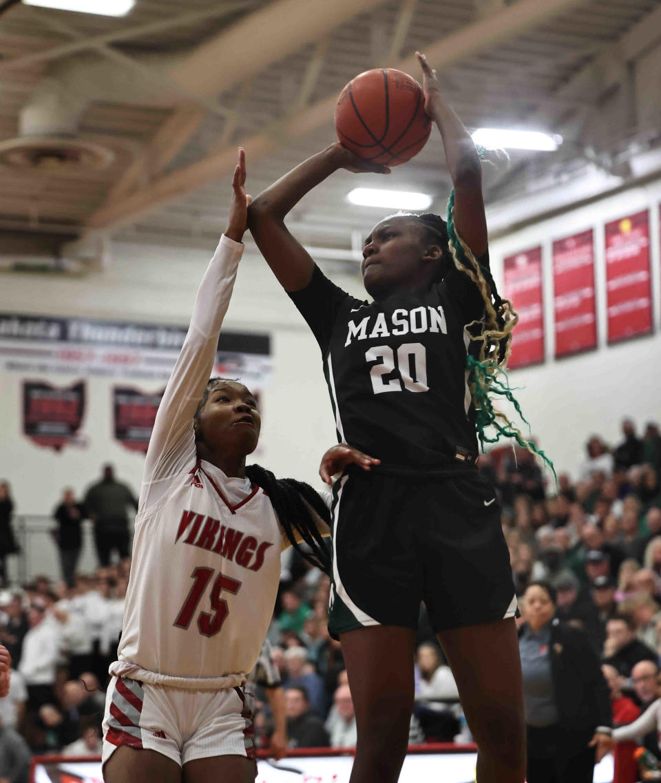 Mason guard Madison Parrish (20) shoots over Princeton's Solè Williams (15) during the OHSAA Division I regional tournament game between Mason and Princeton Tuesday, Feb. 28, 2023.