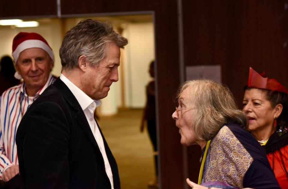 Hugh Grant greets an attendee of the Christmas Day lunch (H&F Council)