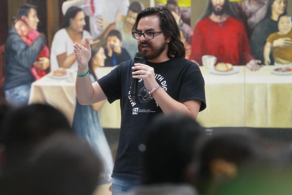 Pedro De Velasco, director of advocacy and education at the Kino Border Initiative, a binational humanitarian organization in Sonora, Nogales, speaks to the more than 200 migrants looking for information on crossing the border in Nogales, Sonora, on May 11, 2023, ahead of the expiration of the Title 42 border restrictions.