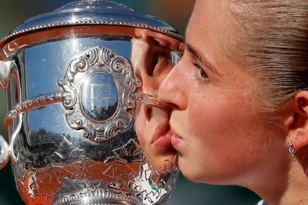 FILE PHOTO: Tennis - French Open - Roland Garros, Paris, France, June 10, 2017 Latvia's Jelena Ostapenko celebrates by kissing the trophy after winning the final against Romania's Simona Halep. REUTERS/Gonzalo Fuentes/File Photo