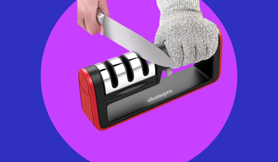 hands using a knife sharpener to sharpen a knife