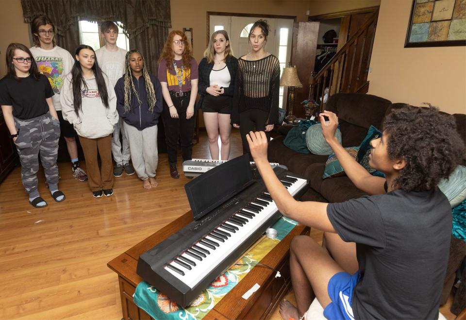Randolph McFarren, at the piano, conducts vocal warmups with the cast of his own musical based on the Jane Austen book "Mansfield Park." The musical hits the stage June 9 and 10.