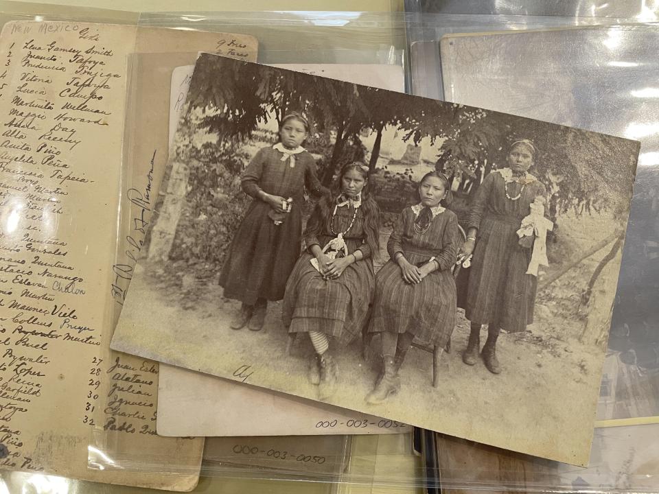 This July 8, 2021 image of material archived at the Center for Southwest Research at the University of New Mexico in Albuquerque, New Mexico, shows a group of unidentified Indigenous students who attended the Ramona Industrial School in Santa Fe. Many of the late 19th century photographs that make up in the Horatio Oliver Ladd Photograph Collection are related to the boarding school. (AP Photo/Susan Montoya Bryan)