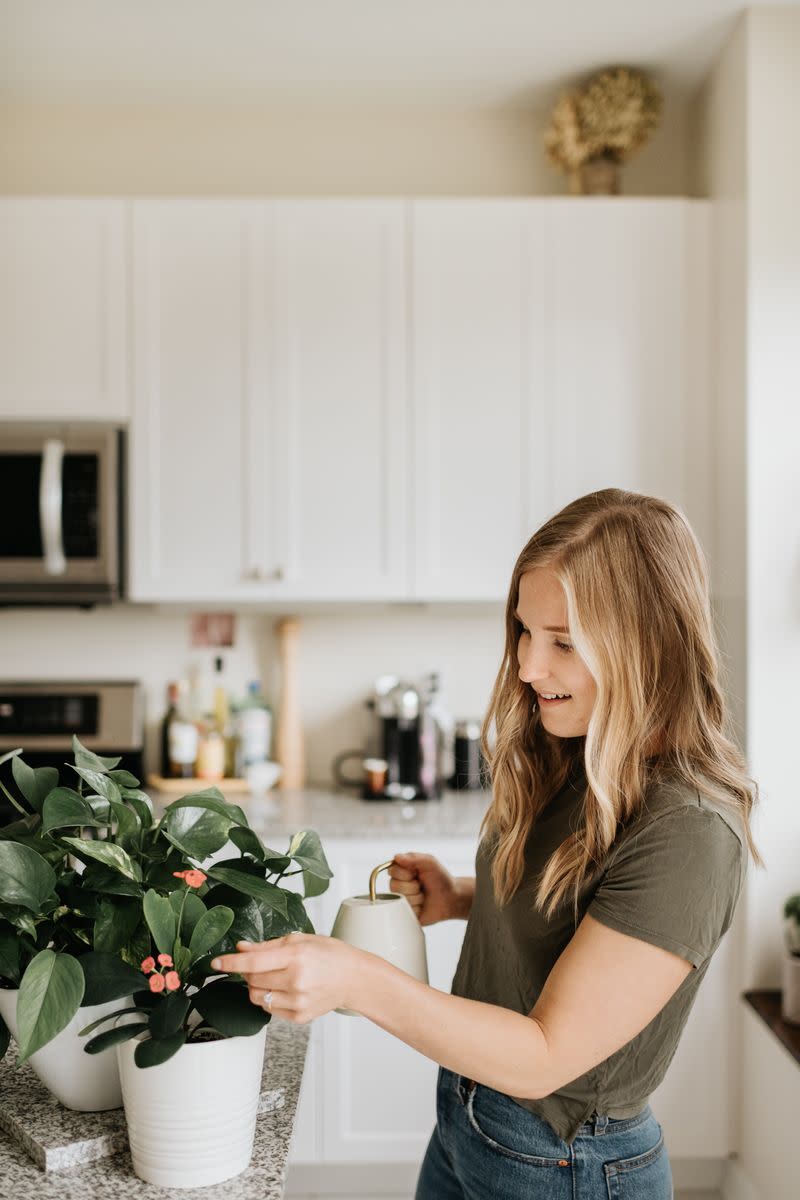 A woman watering house plants