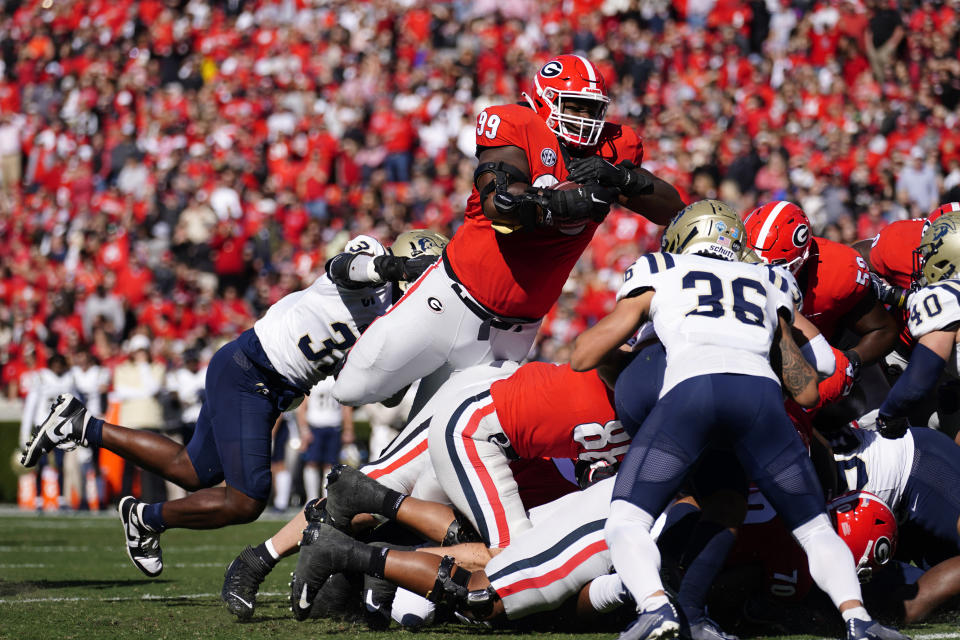 Georgia defensive lineman Jordan Davis (99), who lined up as a running back, is stopped short of the goal line by Charleston Southern defensive lineman Anton Williams (31) in the first half of an NCAA college football game Saturday, Nov. 20, 2021, in Athens, Ga. Davis scored on the following play. (AP Photo/John Bazemore)