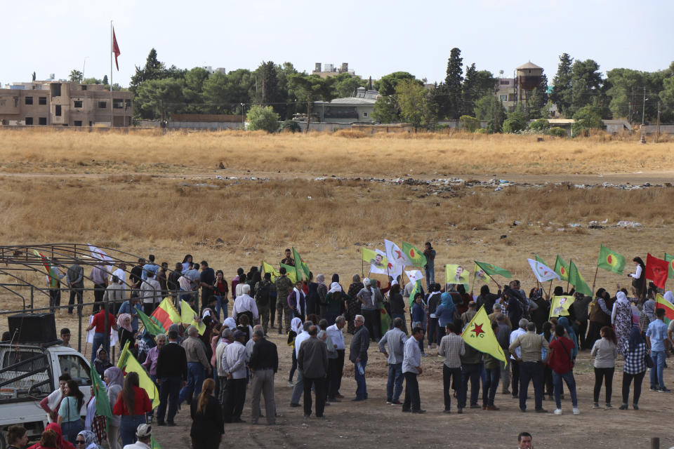 Kurdish citizens wave their group's flags, as they protest against possible Turkish military operation on their areas, at the Syrian-Turkish border, in Ras al-Ayn, Syria, Monday, Oct. 7, 2019. Syria's Kurds accused the U.S. of turning its back on its allies and risking gains made in the fight against the Islamic State group as American troops began pulling back on Monday from positions in northeastern Syria ahead of an expected Turkish assault. (AP Photo)