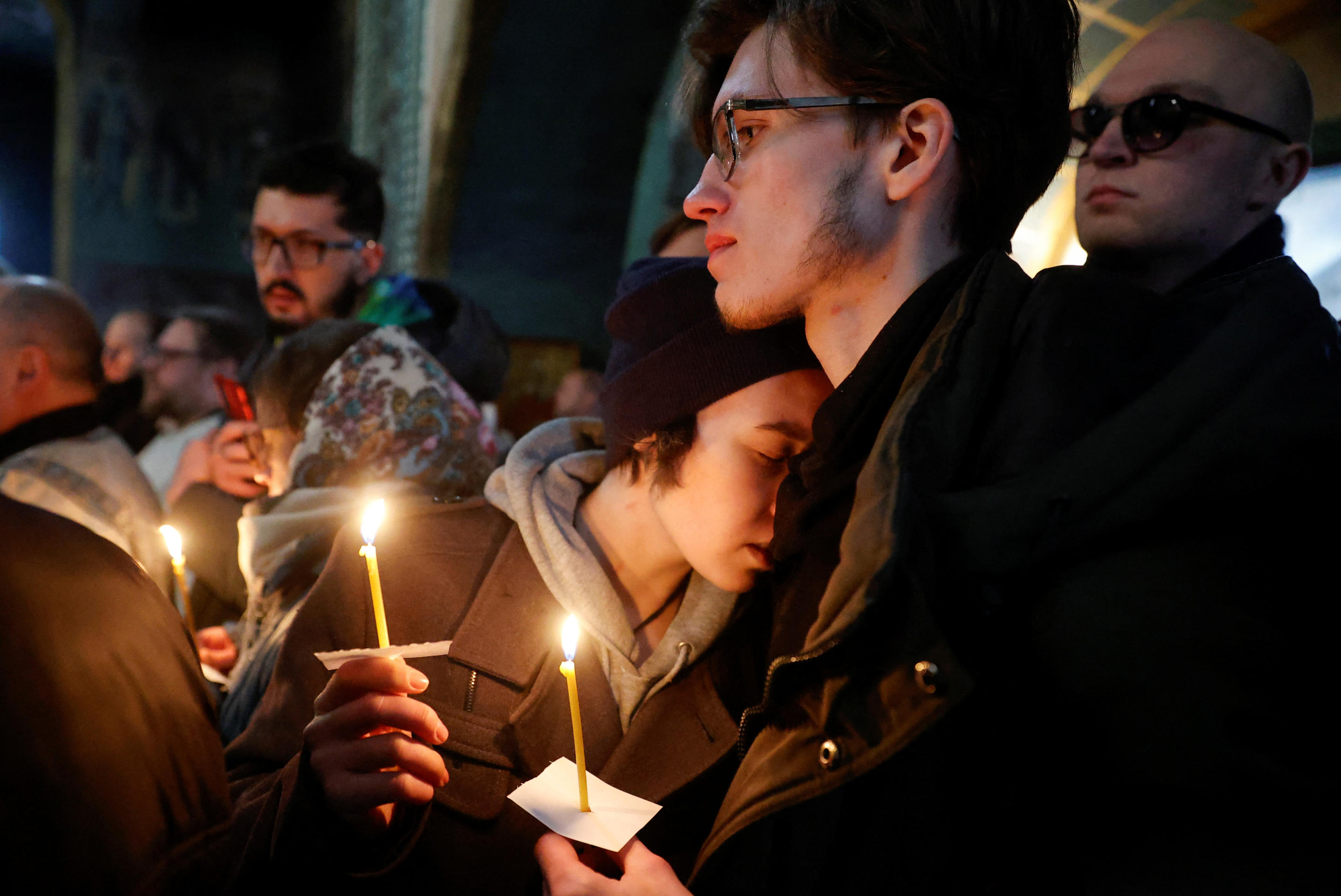 Mourners hold candles during Navalny’s funeral service.