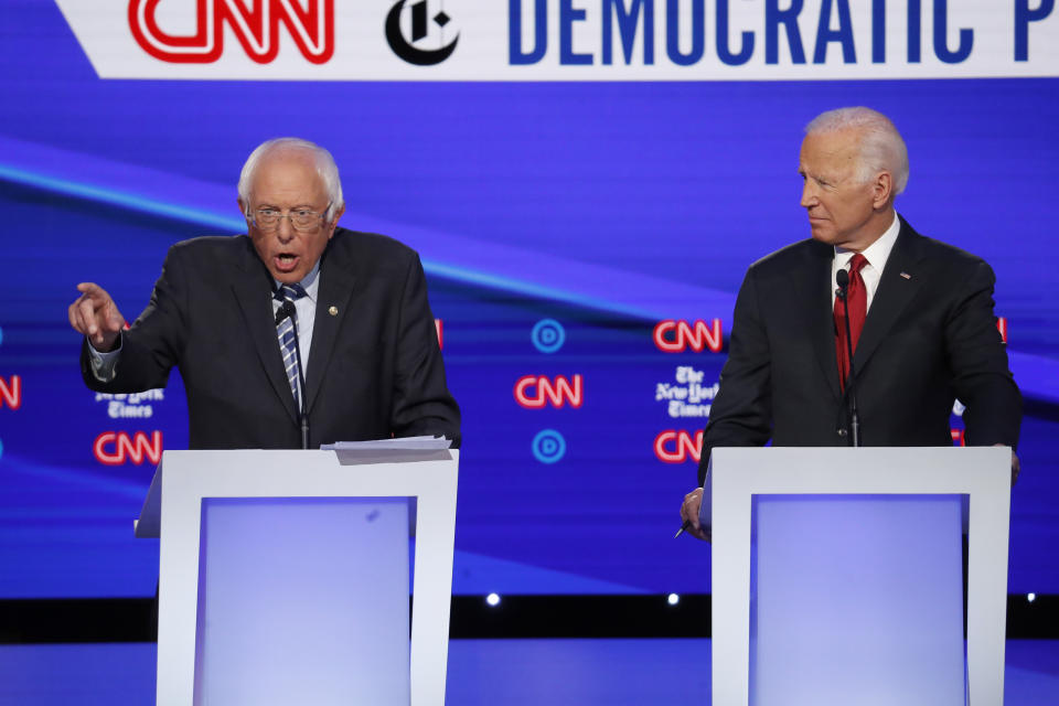 Democratic presidential candidate Sen. Bernie Sanders, I-Vt., left, speaks as former Vice President Joe Biden listens during a Democratic presidential primary debate hosted by CNN/New York Times at Otterbein University, Tuesday, Oct. 15, 2019, in Westerville, Ohio. (AP Photo/John Minchillo)