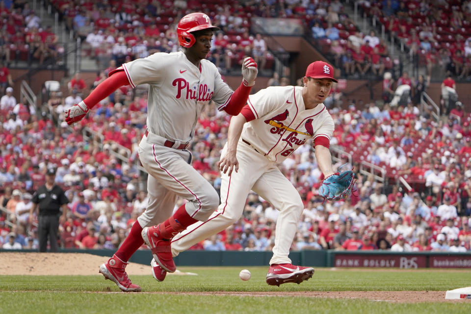 Philadelphia Phillies' Didi Gregorius, left, is safe at first on a bunt single as St. Louis Cardinals relief pitcher Giovanny Gallegos is unable to make a play during the ninth inning of a baseball game Saturday, July 9, 2022, in St. Louis. (AP Photo/Jeff Roberson)