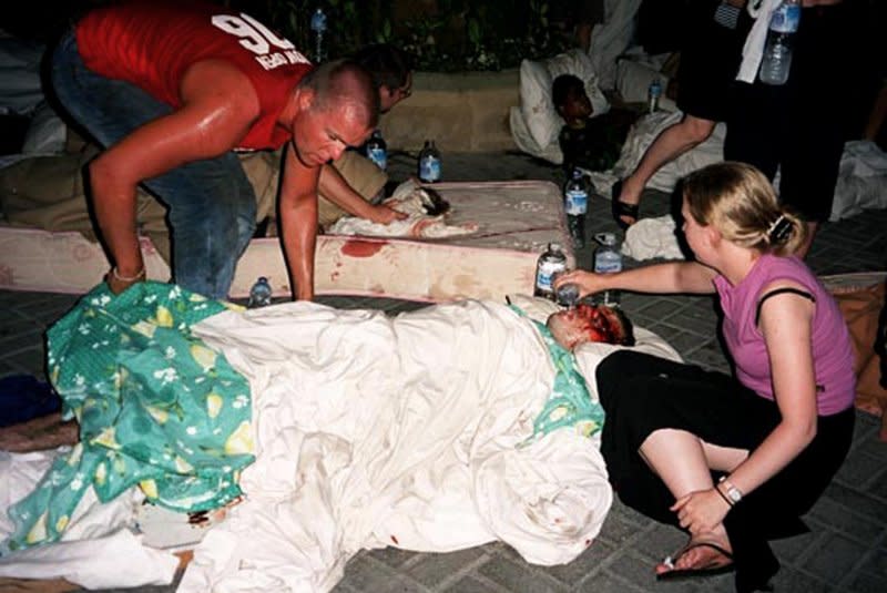 Survivors from a car bomb in Bali, Indonesia, find loved ones and help the injured on October 12, 2002. File Photo by Brian Richards/UPI