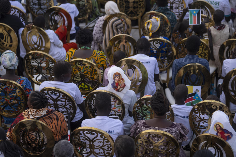 A nun wears headwear showing the Virgin Mary as she and others await the arrival of Pope Francis for a Holy Mass at the John Garang Mausoleum in Juba, South Sudan Sunday, Feb. 5, 2023. Pope Francis is in South Sudan on the final day of a six-day trip that started in Congo, hoping to bring comfort and encouragement to two countries that have been riven by poverty, conflicts and what he calls a "colonialist mentality" that has exploited Africa for centuries. (AP Photo/Ben Curtis)