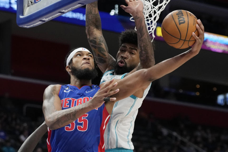 Detroit Pistons forward Marvin Bagley III (35) attempts a basket as Charlotte Hornets center Nick Richards defends during the first half of an NBA basketball game, Thursday, March 9, 2023, in Detroit. (AP Photo/Carlos Osorio)