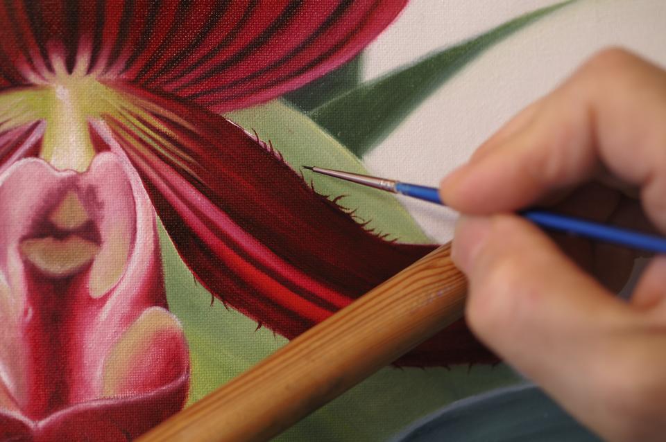 Painting details on an orchid with oil paints 