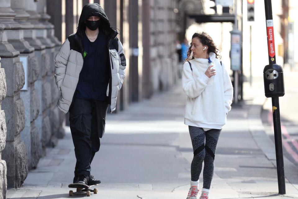 A skateboader wearing a face mask in the City of London: PA