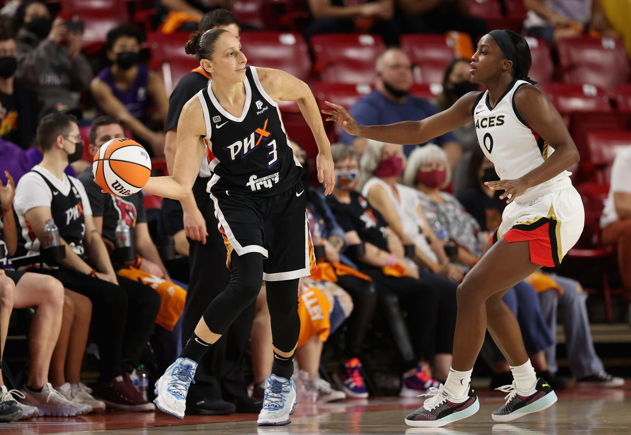 Phoenix's Diana Taurasi attempts to pass the ball around Las Vegas' Jackie Young Game 3 of the 2021 WNBA semifinals at Arizona State's Desert Financial Arena in Tempe, Arizona, on Oct. 3, 2021. (Christian Petersen/Getty Images)