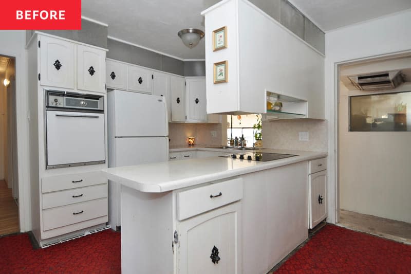 white kitchen with white cabinets and red carpeting before remodel