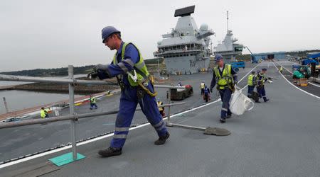 The British aircraft carrier HMS Queen Elizabeth, undergoes preparations for its maiden voyage, in its dock at Rosyth, in Scotland, Britain June 21, 2017. REUTERS/Russell Cheyne