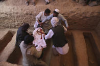 Afghans carry the body of a victim of the Dubai City wedding hall bombing during a mass funeral in Kabul, Afghanistan, Sunday, Aug.18, 2019. The deadly bombing at the wedding in Afghanistan's capital late Saturday that killed dozens of people was a stark reminder that the war-weary country faces daily threats not only from the long-established Taliban but also from a brutal local affiliate of the Islamic State group, which claimed responsibility for the attack. (AP Photo/Rafiq Maqbool)