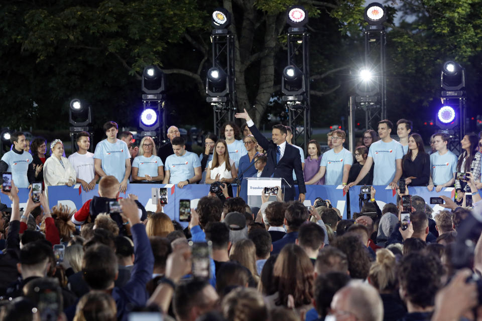 Presidential candidate Rafal Trzaskowski gestures while addressing supporters at the end of the election day in Warsaw, Poland, Sunday, July 12, 2020. Voting ended in Poland's razor-blade-close presidential election runoff between the conservative incumbent Andrzej Duda and liberal, pro-European Union Warsaw Mayor Rafal Trzaskowski with exit polls showing the election is too close to call. (AP Photo/Petr David Josek)