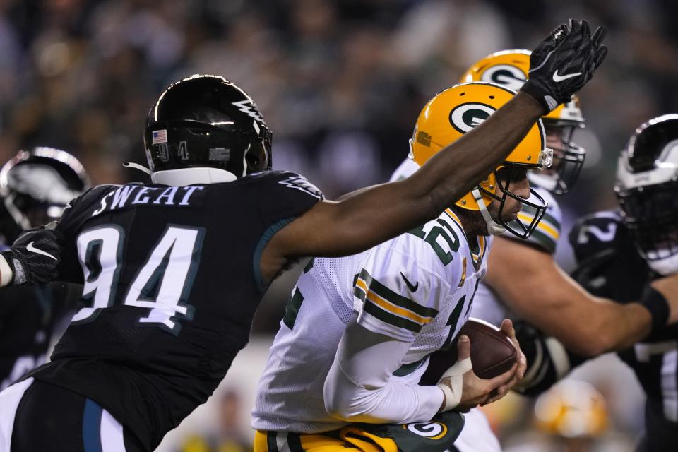 Green Bay Packers quarterback Aaron Rodgers (12) is pressured by Philadelphia Eagles' Josh Sweat (94) during the first half of an NFL football game, Sunday, Nov. 27, 2022, in Philadelphia. (AP Photo/Matt Slocum)