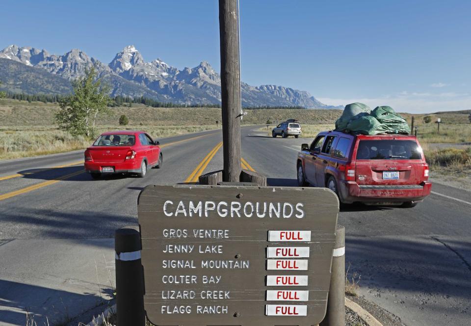 <p>Cars drive into Grand Teton National Park outside Jackson, Wyoming, to experience a total solar eclipse on Monday, August 21, 2017.</p>