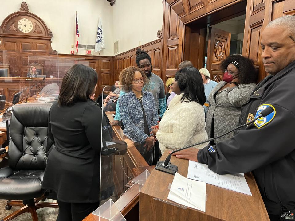 With 15 minutes to meet a charter-imposed deadline Monday night, Akron City Council members Margo Sommerville, left, and Tara Mosley, second from left, console a candidate for the Citizens' Police Oversight Board. Council failed to reach a consensus.