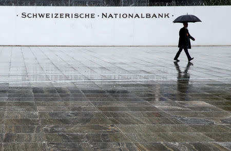 A man walks on the Federal Square in front of the Swiss National Bank (SNB) in Bern, Switzerland June 16, 2016. REUTERS/Ruben Sprich/File Photo