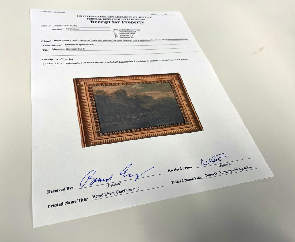 This photo shows a U.S. Department of Justice receipt for property transferring ownership of the 18th century painting titled "Landscape of Italian Character" by Vienna-born artist Johann Franz Nepomuk Lauterer, Thursday, Oct. 19, 2023 in Chicago. After going missing nearly 80 years ago, the "Landscape of Italian Character", a baroque landscape painting was returned to a German museum representative in a brief ceremony at the German Consulate in Chicago, where the pastoral piece of an Italian countryside was on display. (AP Photo/Claire Savage)