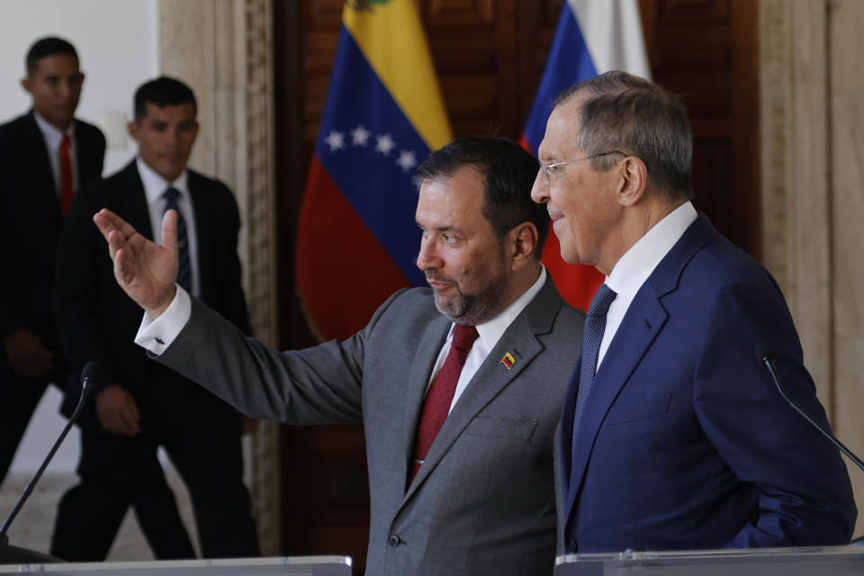 Venezuela's Foreign Minister Yvan Gil, left center, and Russia's Foreign Minister Sergei Lavrov, talk after a press conference at the Foreign Ministry in Caracas, Venezuela, Tuesday, April 18, 2023. (AP Photo/Jesus Vargas)