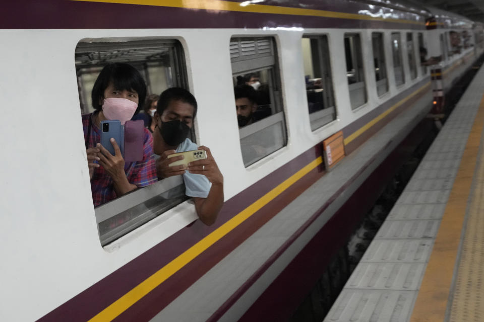 Passengers take pictures as they depart for the southern province of Narathiwat at the Krung Thep Aphiwat Central Terminal in Bangkok, Thailand, Thursday, Jan. 19, 2023. Thailand ushered in a new age of train travel on Thursday when what’s said to be Southeast Asia’s biggest railway station officially began operations. (AP Photo/Sakchai Lalit)