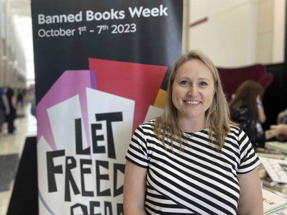 CORRECTS YEAR TO 2023 - South Carolina school librarian Jamie Gregory smiles in front of the Banned Books station at the American Library Association's annual conference in downtown Chicago, Saturday, June 24, 2023. Attendees are invited to climb atop a giant chair to read their favorite banned book for all to see. (AP Photo/Claire Savage)