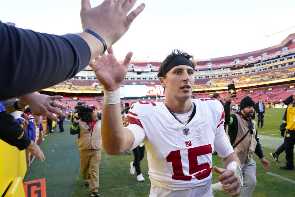 New York Giants quarterback Tommy DeVito (15) greeting fans as he leaves the field at the end of an NFL football game against the Washington Commanders, Sunday, Nov. 19, 2023, in Landover, Md. Giants won 31-19. (AP Photo/Andrew Harnik)