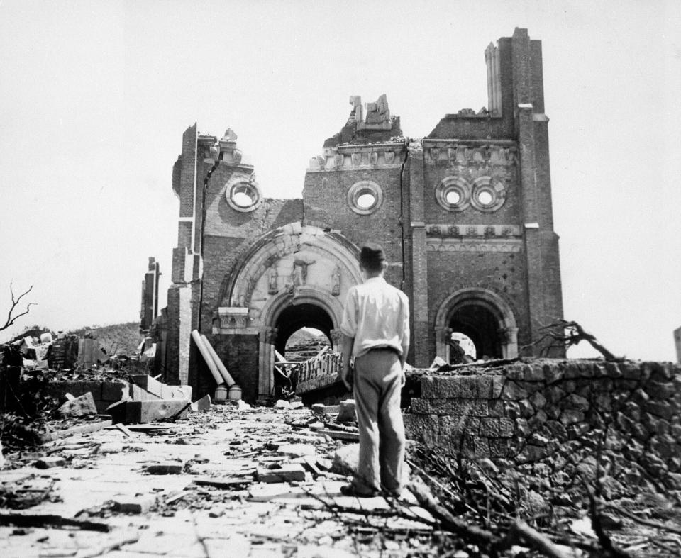 FILE - In this Sept. 13, 1945, file photo, the Urakami Catholic Cathedral in Nagasaki, Japan, stands waste in the aftermath of the detonation of the atom bomb over a month ago over this city. Many residents of Hiroshima welcome attention to their city from abroad, which IOC President Thomas Bach will bring when he visits on Friday, July 16. But Bach will also bring political baggage — as will his vice president John Coates when he visits Nagasaki the same day — that is largely unwelcome in two cities viewed as sacred by many Japanese.(AP Photo/Stanley Troutman, Pool, File)