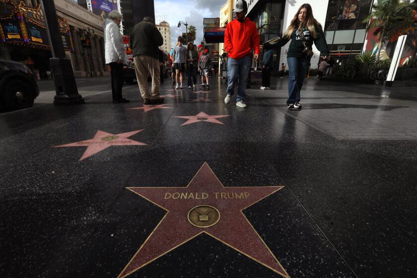 HOLLYWOOD, CA - DECEMBER 22, 2023 - Visitors walk towards Donald Trump's star on the Hollywood Walk of Fame in Hollywood on December 22, 2023. Andrew Rudick, a 35-year-old former casting associate who has been working tirelessly since 2020 to get the city of L.A. to remove Donald Trump's star from the Hollywood Walk of Fame. He's obsessed with getting the star removed, but it's never been done before so there's no precedent or process in place to do so. (Genaro Molina/Los Angeles Times)