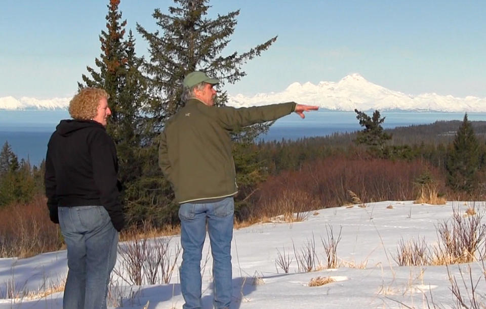 In this April 1, 2013 photo provided by Storyknife, author Dana Stabenow, left, looks over the proposed side for the Storyknife Writer's Retreat with the non-profit's construction director, Scott Baueroutside, right, near Homer, Alaska. Stabenow has announced plans to create th retreat. This will include a main building and six cabins where women writers will do nothing during their residency except write. The project is in the fund-raising phase. Stabenow is a former worker on Alaska’s North Slope who has written 29 novels, and is best known for her Kate Shugak mystery novels. (AP Photo/Storyknife, Nathan Havey)
