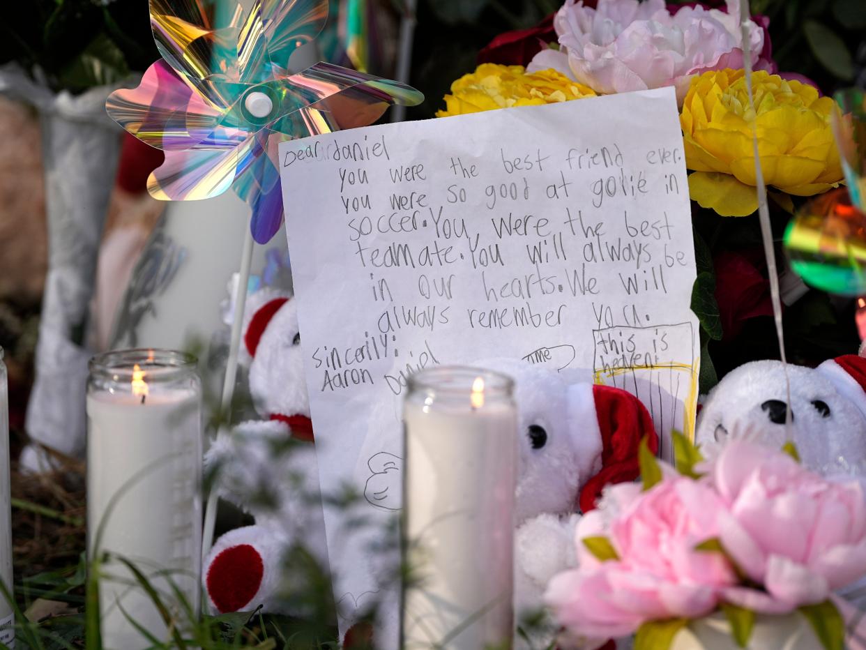 A letter sits among items left by neighbors during a vigil, Monday, May 1, 2023, outside the home where a mass shooting occurred Friday, in Cleveland, Texas.