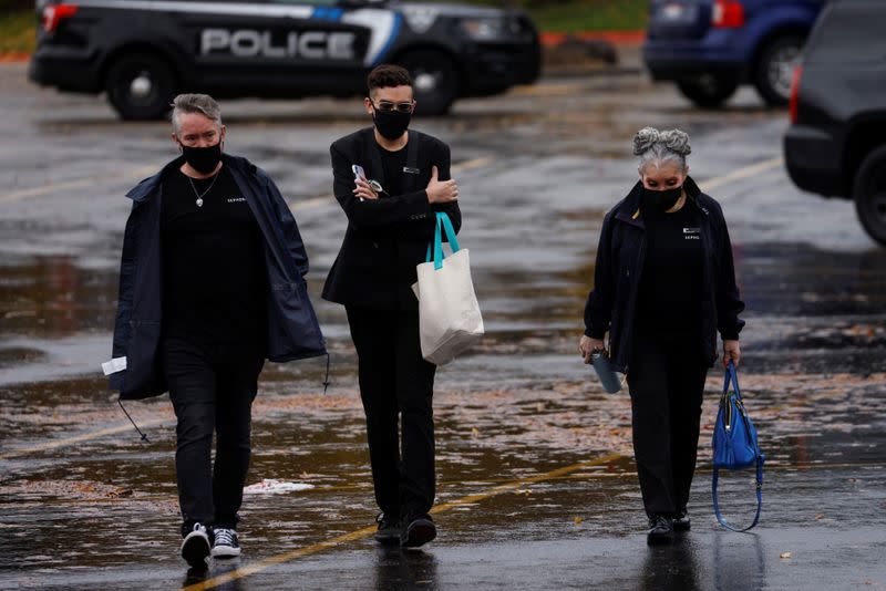 People walk in a parking lot near the scene of a shooting at the Boise Towne Square shopping mall in Boise, Idaho