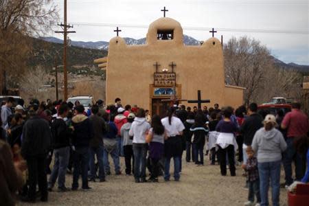 Participants in a Good Friday pilgrimage stop at San Juan de los Lagos capilla in Talpa, New Mexico March 29, 2013. REUTERS/Brian Snyder