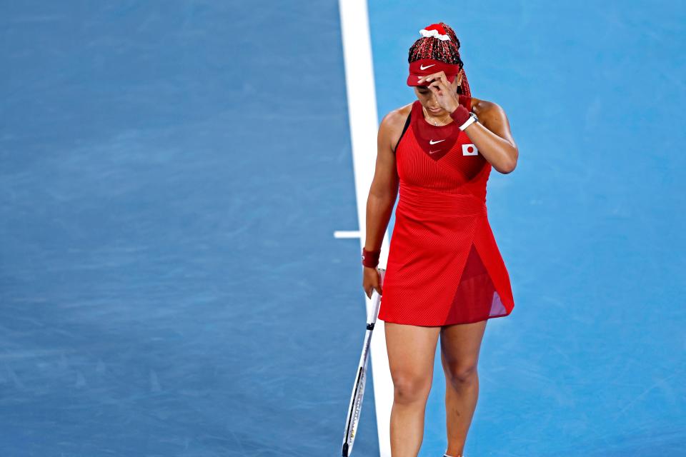 Naomi Osaka (JPN) reacts to her loss Marketa Vondrousova (CZE) in the women's tennis third round singles during the Tokyo 2020 Olympic Summer Games at Ariake Tennis Park.