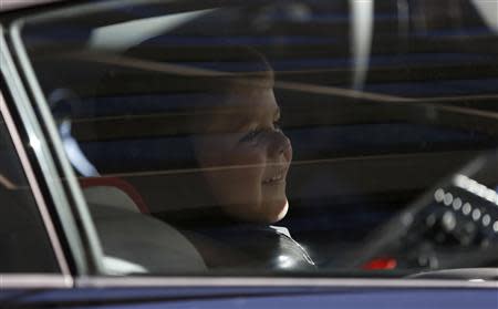 Five-year-old leukemia survivor Miles Scott, dressed as "Batkid" smiles as he sits in the Batmobile after he and Batman apprehended The Riddler as part of a day arranged by the Make- A - Wish Foundation in San Francisco, California November 15, 2013. REUTERS/Stephen Lam