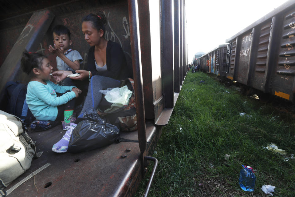 A migrant mother and children ride a freight train on their way north, in Palenque, Chiapas state, Mexico, Monday, June 24, 2019. Their next stop will be Coatzacoalcos, Veracruz state. Mexico has deployed 6,500 National Guard members in the southern part of the country, plus another 15,000 soldiers along its northern border in a bid to reduce the number of migrants traveling through its territory to reach the U.S. (AP Photo/Marco Ugarte)