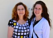 Gloria Snekszer, left, and her daughter, Amanda, who came to Guantanamo to observe legal pretrial proceedings in the case of five men charged in the Sept. 11, 2001, terrorist attack, pose for a photo at the U.S. naval base in Guantanamo, Cuba, April 17, 2014. Gloria Snekszer’s sister, Vicki Linn Yancey, was aboard American Airlines Flight 77, which crashed into the Pentagon. (AP Photo/Stijn Hustinx)