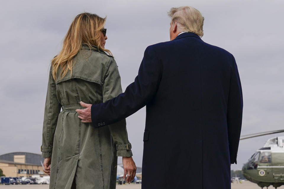 President Donald Trump walks with first lady Melania Trump after speaking to reporters before boarding Air Force One for a day of campaign rallies in Michigan, Wisconsin, and Nebraska, Tuesday, Oct. 27, 2020, at Andrews Air Force Base, Md. The first lady will be campaigning in Pennsylvania. (AP Photo/Evan Vucci)